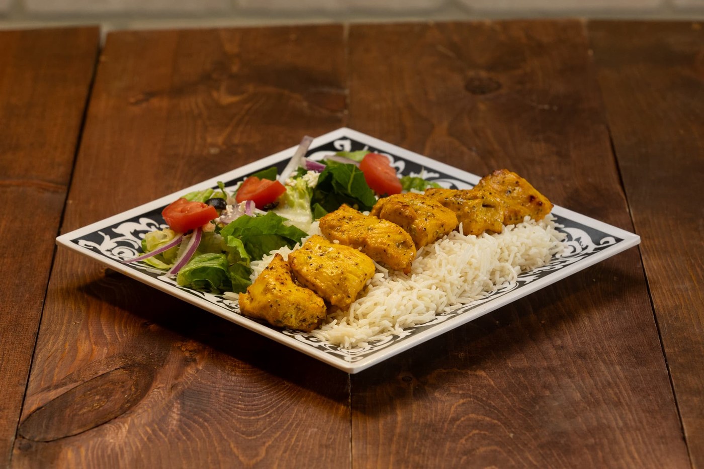 Chicken kabob plate with rice and salad